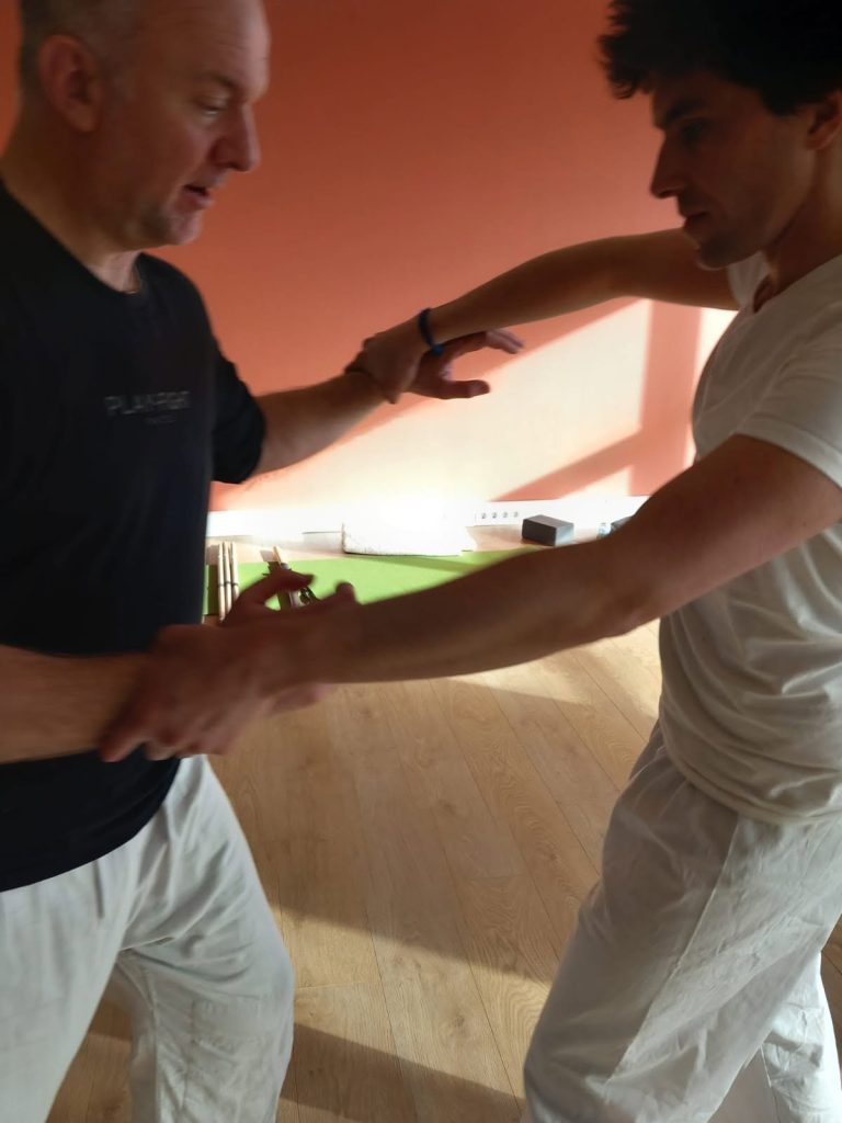 Richard Jacobsen practising a mindful movement exercise with a participant