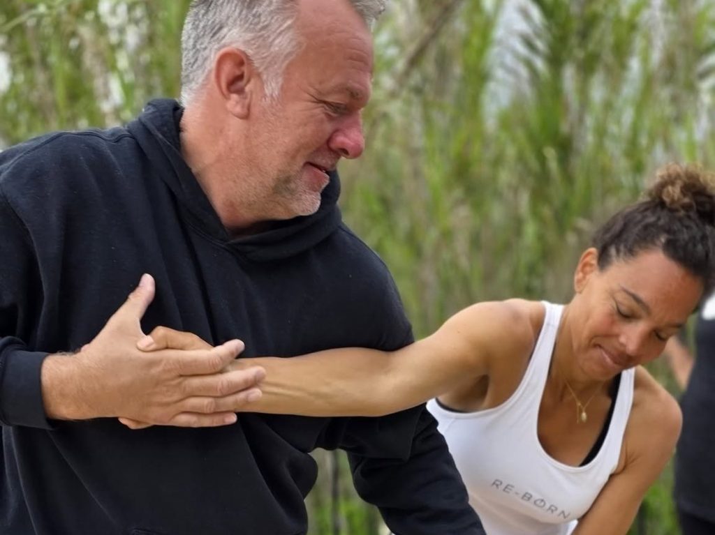 Richard Jacobsen leading an outdoor movement exercise in pairs