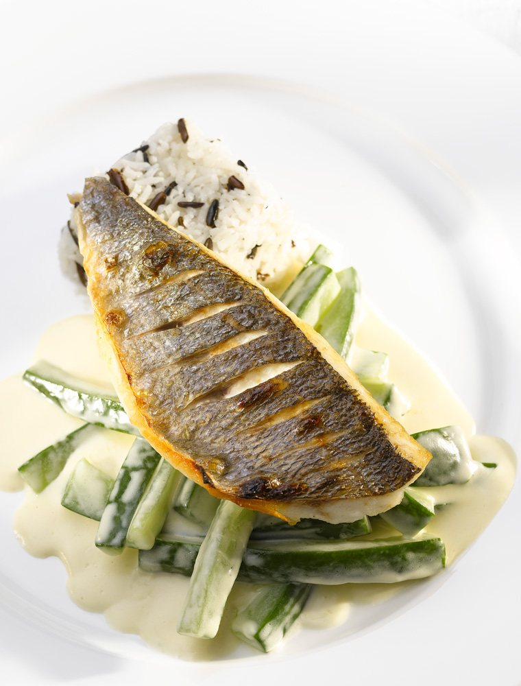 Pan-fried sea bass fillet on creamy courgette with wild rice
