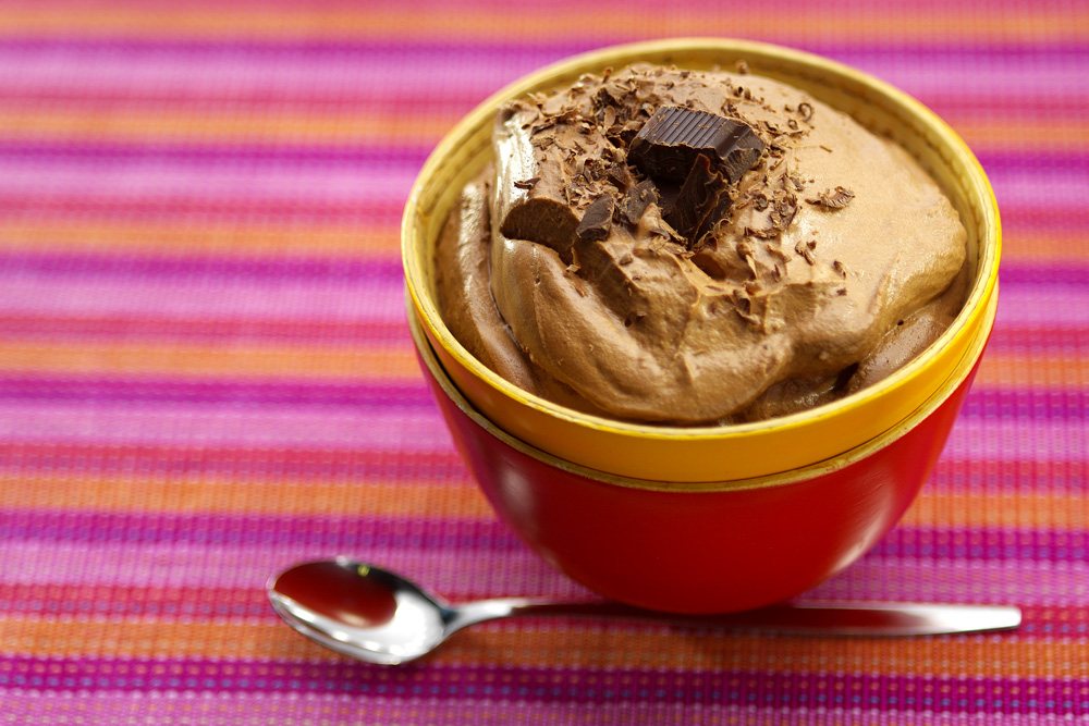 Chocolate mousse with chocolate shavings in a red bowl