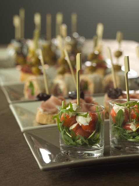 Canapés and amuse-bouches in glasses on a buffet