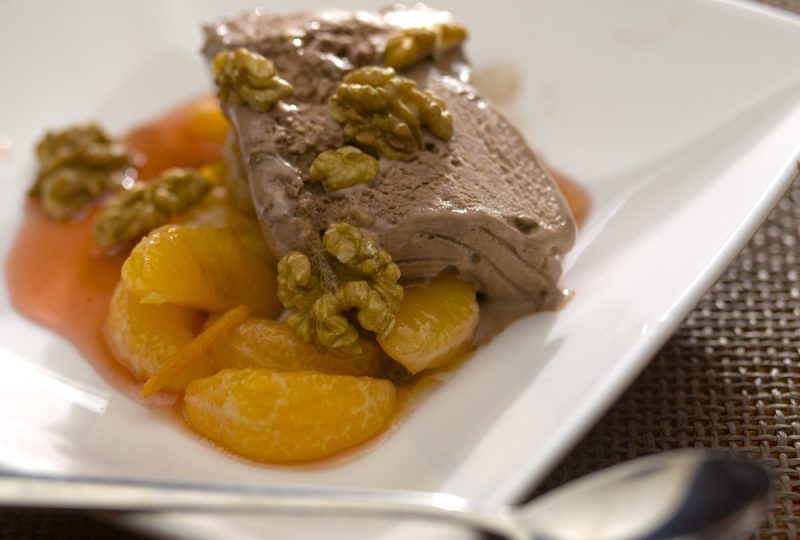 Chocolate ice cream with mandarin and walnuts