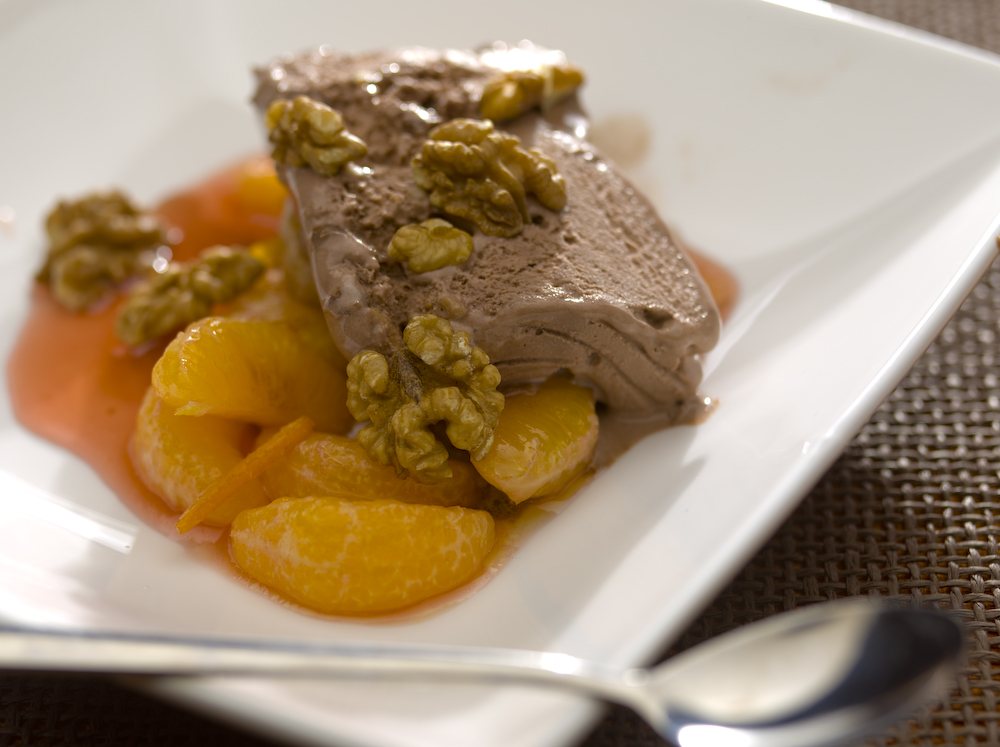 Chocolate ice cream with mandarin and walnuts