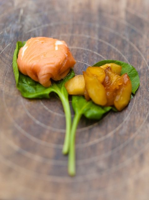 Salmon with fried apple on a bed of spinach
