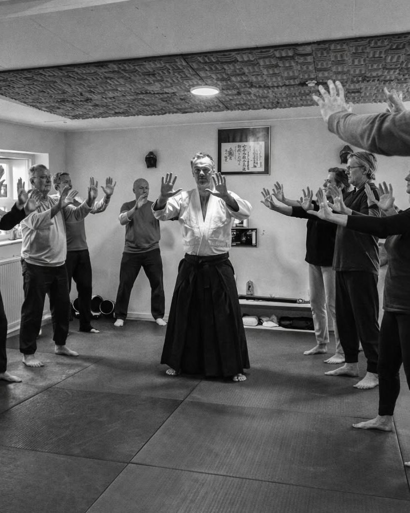 Richard Jacobsen leading a Qi Gong session with participants in a circle
